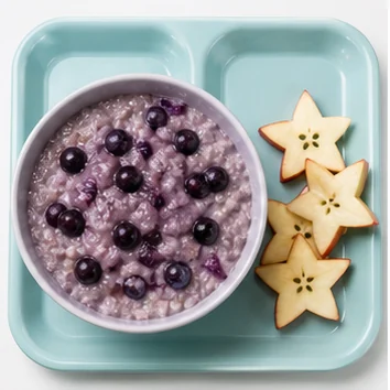 Lavender oatmeal with dark moonberries and star-shaped apple slices.