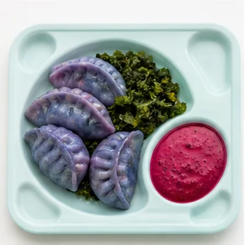 Violet dumplings served with green vegetables and bright magenta sauce.