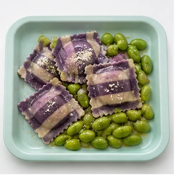 Purple striped ravioli served beside bright green beans.