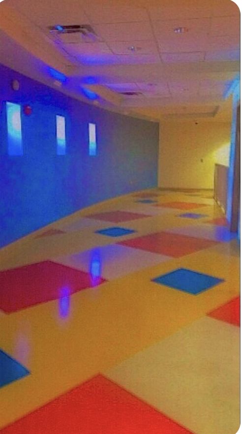 A colorful blue-lit hallway inside Eyeview Elementary.